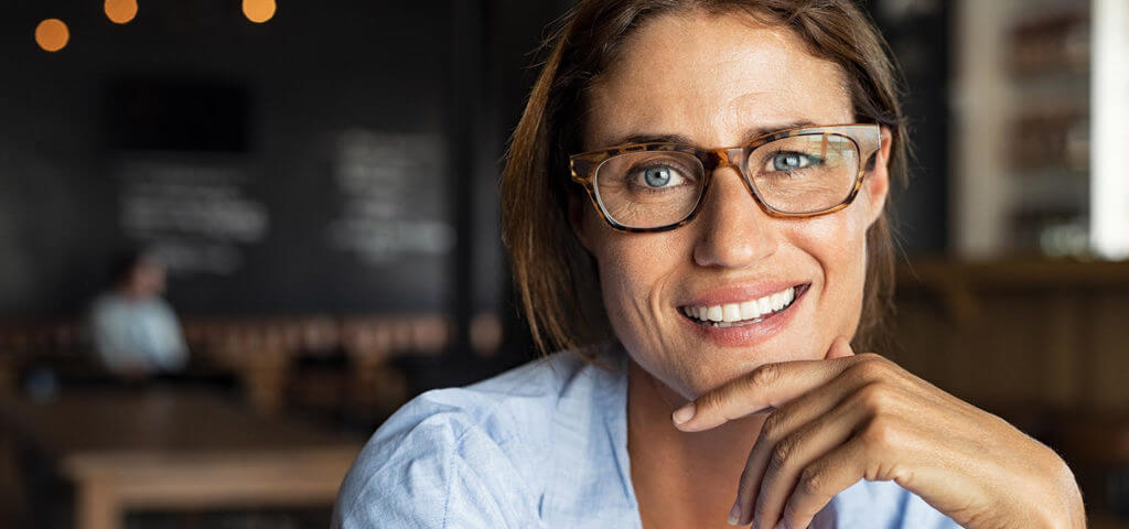 woman wearing glasses, smiling